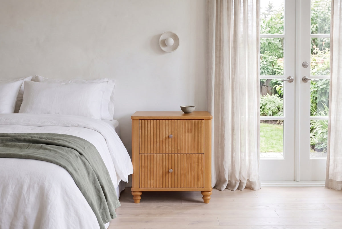 Palestrina nightstand in Natural beside a white linen bed in a bright Victoria bedroom with French doors to the garden