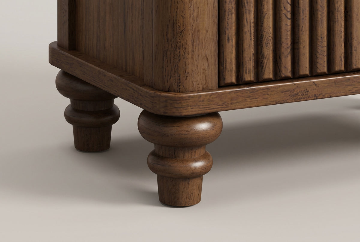 Close-up of the Palestrina base: the rounded base corner and a turned walnut bun foot
