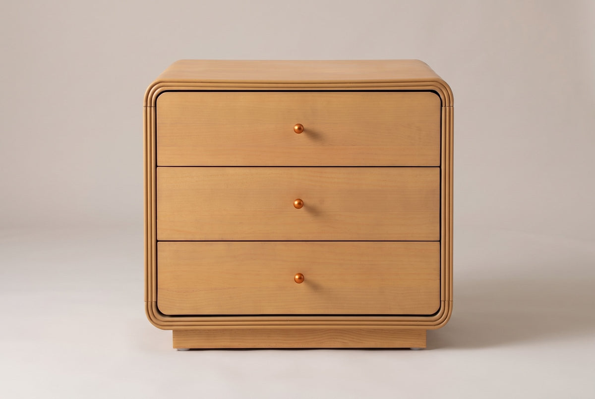 Parma nightstand in Natural, straight front view: three drawers, three ball knobs, a grooved surround and a recessed plinth