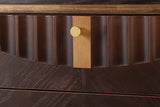 Close-up of the Pavia top drawer in Dark Brown: carved flutes cut along an arc, the gold-tone plate and knob