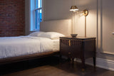 Pavia nightstand in Dark Brown beside a bed in a panelled Ottawa townhouse bedroom at dusk