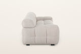 Pergola sofa in Beige, side view on a warm white studio backdrop: a round roll at the end of the back above the low puffed ar