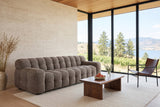 Pergola sofa in Brown seen from above at the front left in a Penticton house, travertine walls