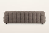 Back of the Pergola sofa in Brown on a warm white studio backdrop: the back is puffed in rows of rounded channels too