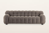 Pergola sofa in Brown, straight front view on a warm white studio backdrop: rounded puffs across the back