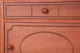 Close-up of the Perugia drawer front with three routed panels and a round wooden knob