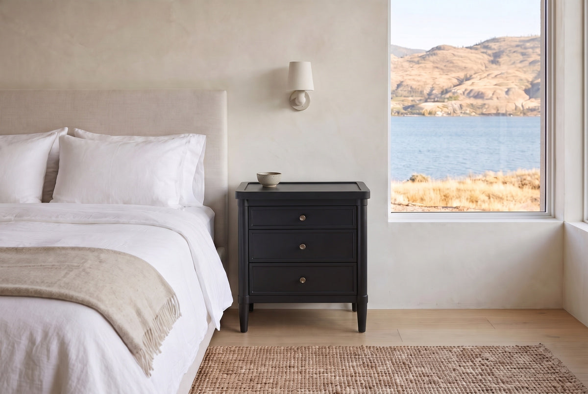 Pescara nightstand in Black beside a bed in a Kelowna lake house bedroom with a view of the lake and dry hills