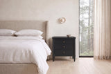 Pescara nightstand in Black beside a bed with white linen in a plaster Vancouver bedroom with a misty cedar view