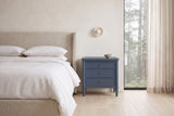 Pescara nightstand in Navy Blue beside a bed with white linen in a plaster Vancouver bedroom with a misty cedar view