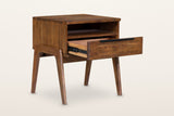 Pescasseroli nightstand in Brown with the drawer pulled out, three-quarter view on a warm white studio backdrop