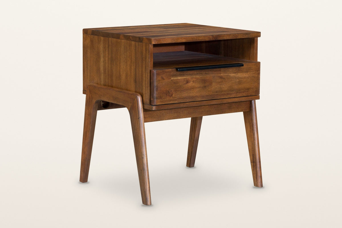 Pescasseroli nightstand in Brown acacia, three-quarter view on a warm white studio backdrop: an open niche over one drawer wi
