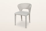 Petralia dining chair in Beige tweed, three-quarter view on a warm white studio backdrop