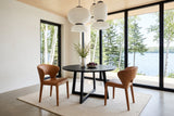 Two Petralia dining chairs in Brown leather seen from above at a round black ash table in a Waskesiu lake house