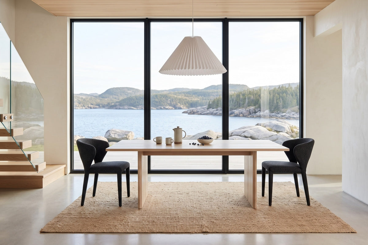 Petralia dining chairs in Dark Grey at each end of a bleached-oak table in a Brigus harbour house