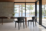 Two Petralia dining chairs in Dark Grey seen from behind at a dark walnut table in a Kenora lake house