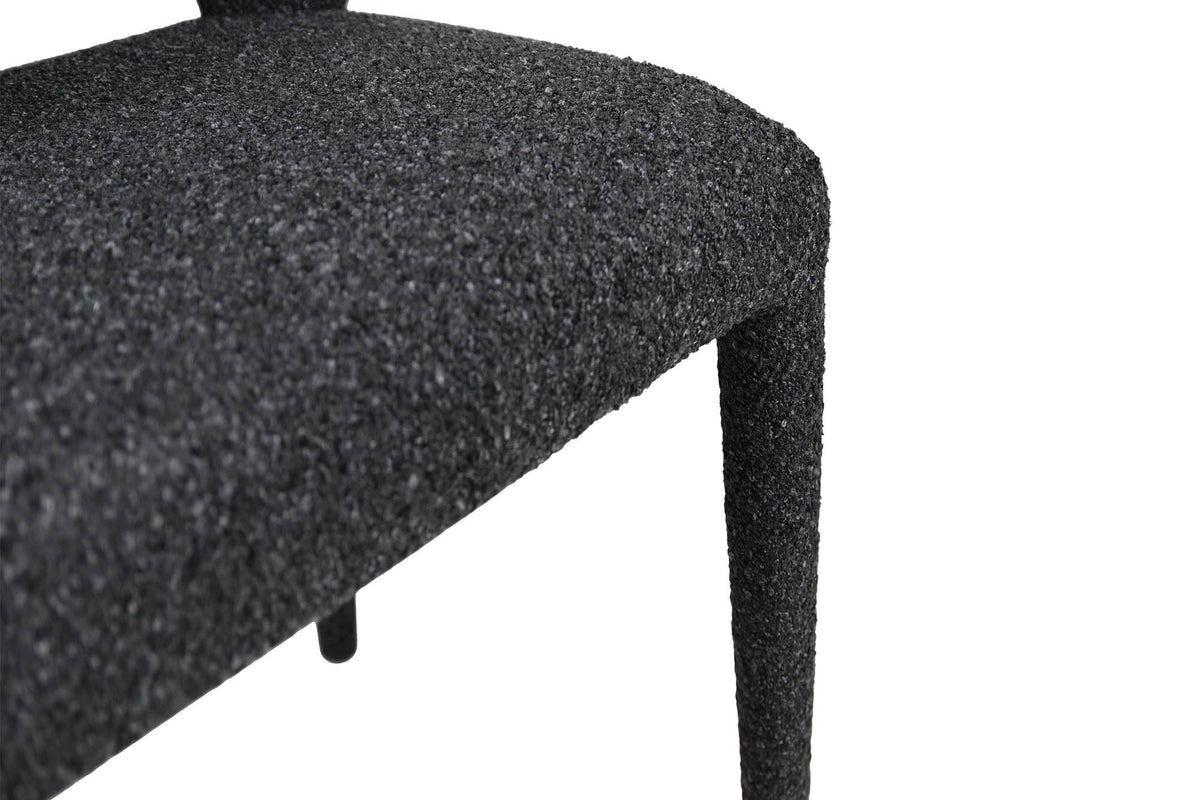Close-up of the Petralia seat and a front leg in Dark Grey: the thick seat and the fabric wrapped down the tapered leg