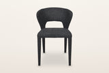 Petralia dining chair in Dark Grey, straight front view on a warm white studio backdrop: the open window between the seat