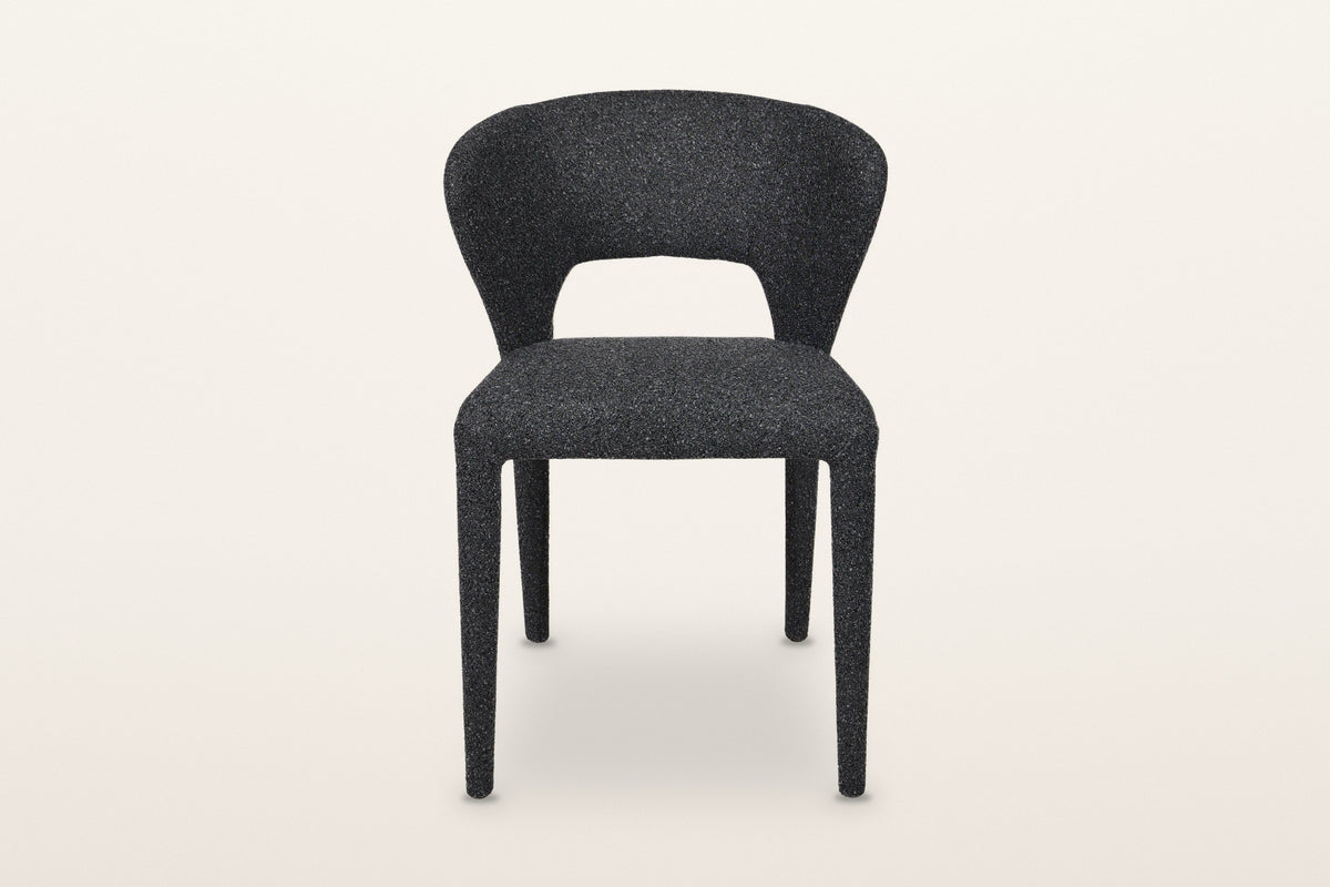 Petralia dining chair in Dark Grey, straight front view on a warm white studio backdrop: the open window between the seat