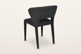 Petralia dining chair in Dark Grey from the back at three-quarter on a warm white studio backdrop
