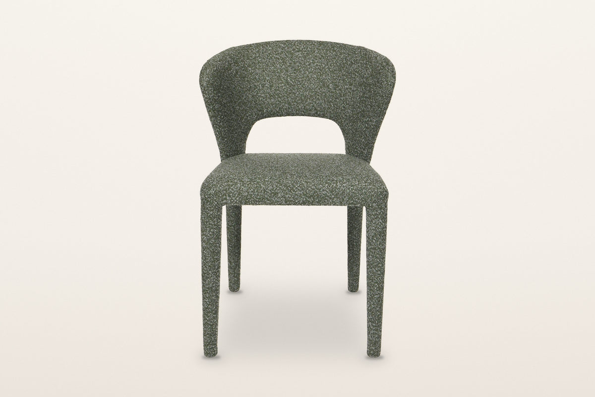 Petralia dining chair in Green, straight front view on a warm white studio backdrop: the open window between the seat