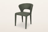 Petralia dining chair in Green, three-quarter view on a warm white studio backdrop