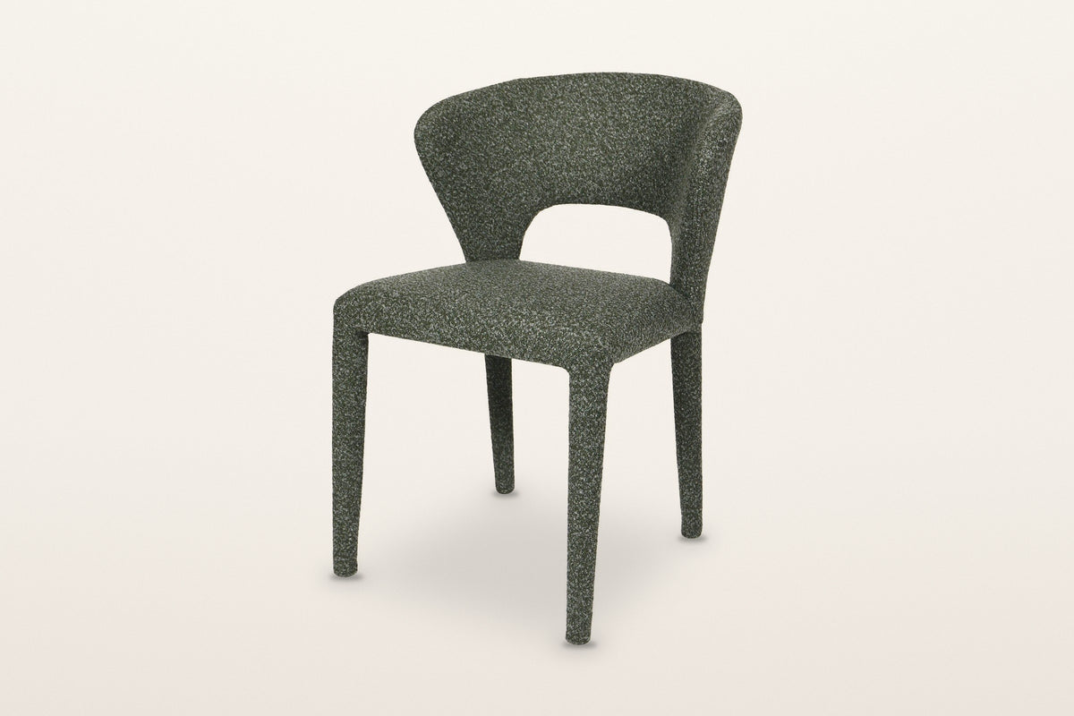 Petralia dining chair in Green, three-quarter view on a warm white studio backdrop
