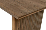 Close-up of a Pettorano corner in Brown: reclaimed pine planks with knots, the stepped edge, and the reeded slab below