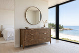 Pettorano dresser in Brown reclaimed pine under a round mirror in a Lockeport beach house bedroom, with lime plaster walls