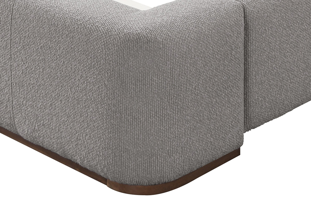 Pierce bed close-up of the rounded footboard corner and walnut-finished wood base