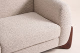 Close-up of the almond boucle seat cushion and the rounded arm
