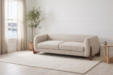Pistoia sofa in a bright Halifax living room with white shiplap walls, an olive tree and a window onto the harbour