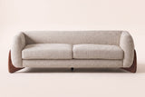 Pistoia sofa in almond boucle, straight front view: two seat cushions, a tight back, rounded arms and wedge feet