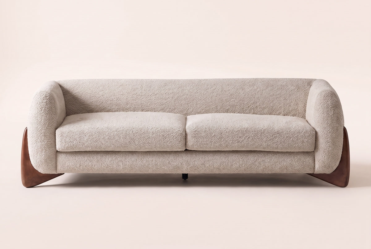 Pistoia sofa in almond boucle, straight front view: two seat cushions, a tight back, rounded arms and wedge feet
