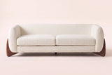 Pistoia sofa in Beige boucle, straight front view: rounded wrap-around arms, two seat cushions and walnut wedge feet