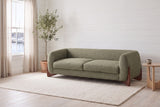 Pistoia sofa in Olive Green boucle in a bright Halifax room with shiplap walls, an olive tree and the harbour through the window
