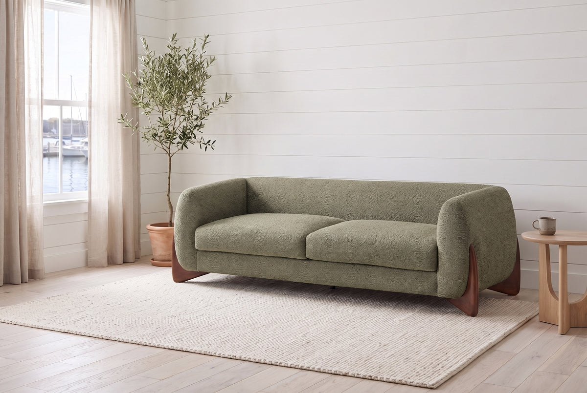 Pistoia sofa in Olive Green boucle in a bright Halifax room with shiplap walls, an olive tree and the harbour through the window