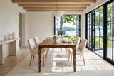 End view of the Polcenigo dining table in Dark Burl in a Chester house on Mahone Bay, with limewashed walls, oak beams