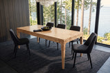 Polcenigo dining table in Honey Blonde Burl seen from above at the corner in a Powell River house, with smoked-oak panelling