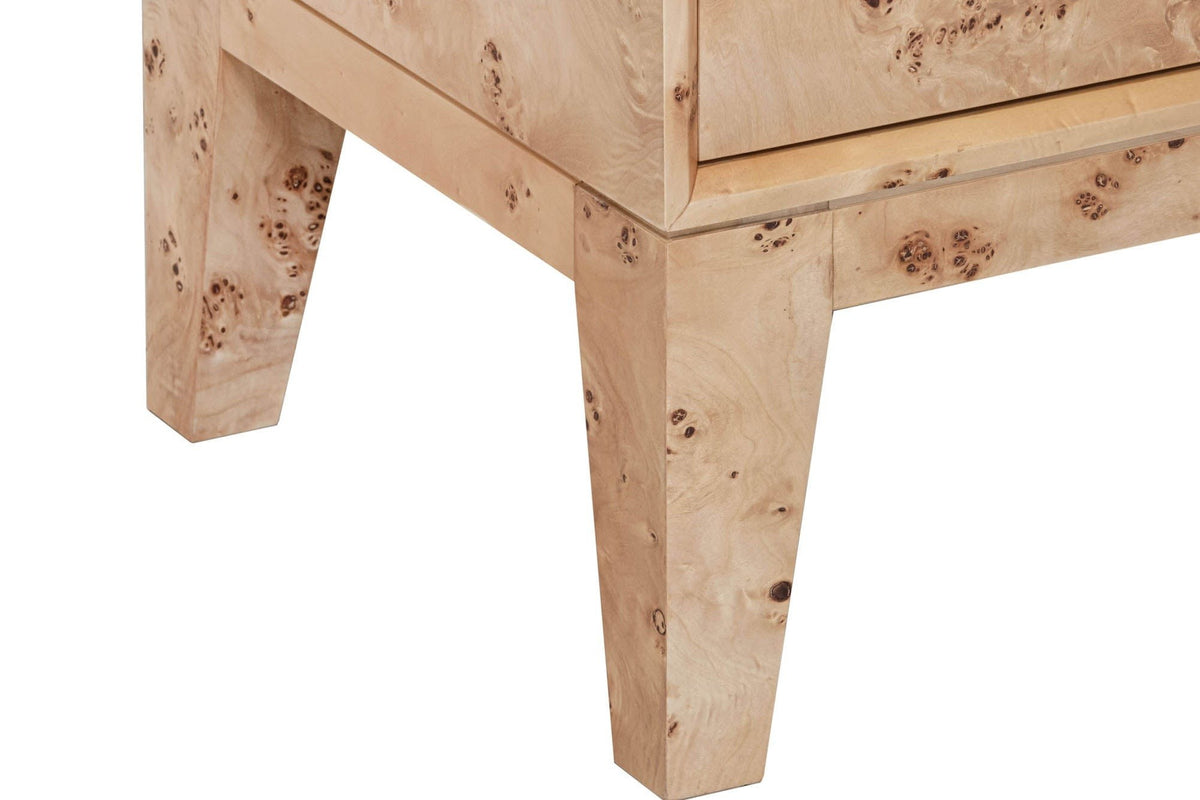 Close-up of the Polcenigo sideboard in Honey Blonde Burl at a corner: the bottom of a door, a thin shadow line