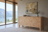 Polcenigo sideboard in Honey Blonde Burl against a greige plaster wall in a house on Shuswap Lake, with a travertine floor