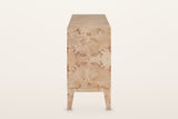 Polcenigo sideboard in Honey Blonde Burl, end view on a warm white studio backdrop: a book-matched burl end panel over the ra