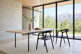 Two Pollica dining chairs in Black at a pale ash table in a Crowsnest Pass house