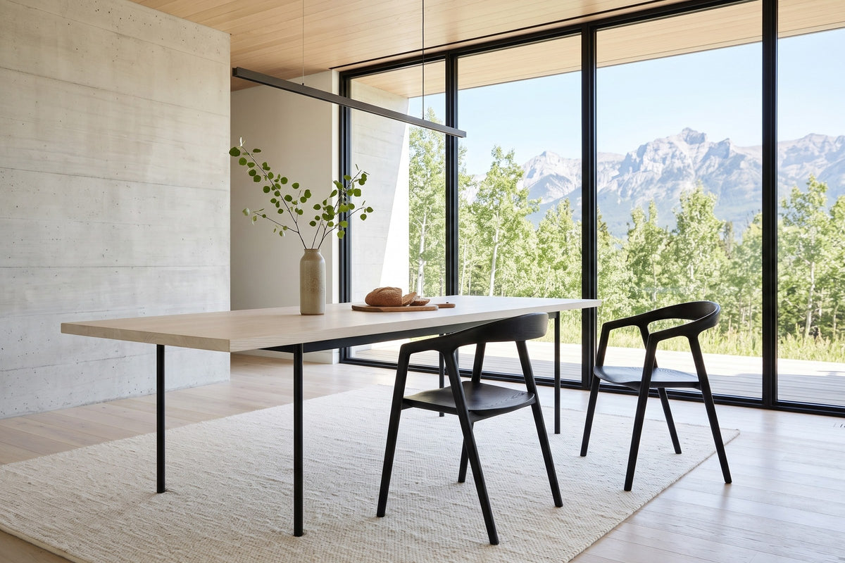 Two Pollica dining chairs in Black at a pale ash table in a Crowsnest Pass house