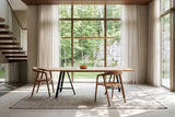 Two Pollica dining chairs in Caramel at the ends of a long white-oak table in a Mono Cliffs house