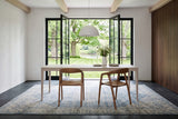 Two Pollica dining chairs in Caramel seen from behind at a whitewashed oak table in a Perth stone house