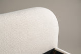 Close-up of the rounded corner of the Pollutri headboard in cream white boucle