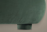 Close-up of the rounded end of the Pollutri foot rail and a short round foot, both in dark green velvet