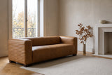 Pontremoli leather sofa in Latte in an Outremont, Montreal living room with herringbone parquet and a white fireplace