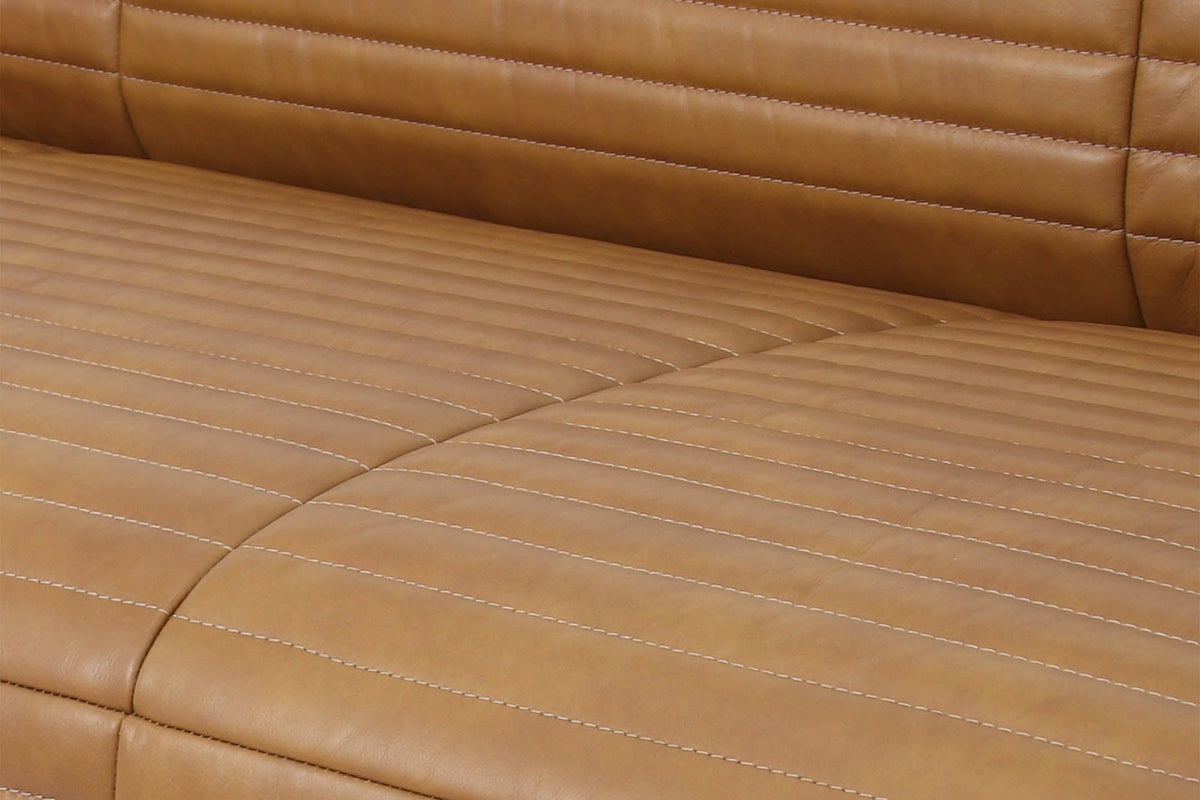 Close-up of the Pontremoli seat: light tan top-stitching along the channels and the seam between two seat cushions
