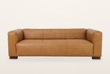 Pontremoli sofa from the front: three seat cushions, three back panels and two square block arms, all channel-stitched, on four block feet